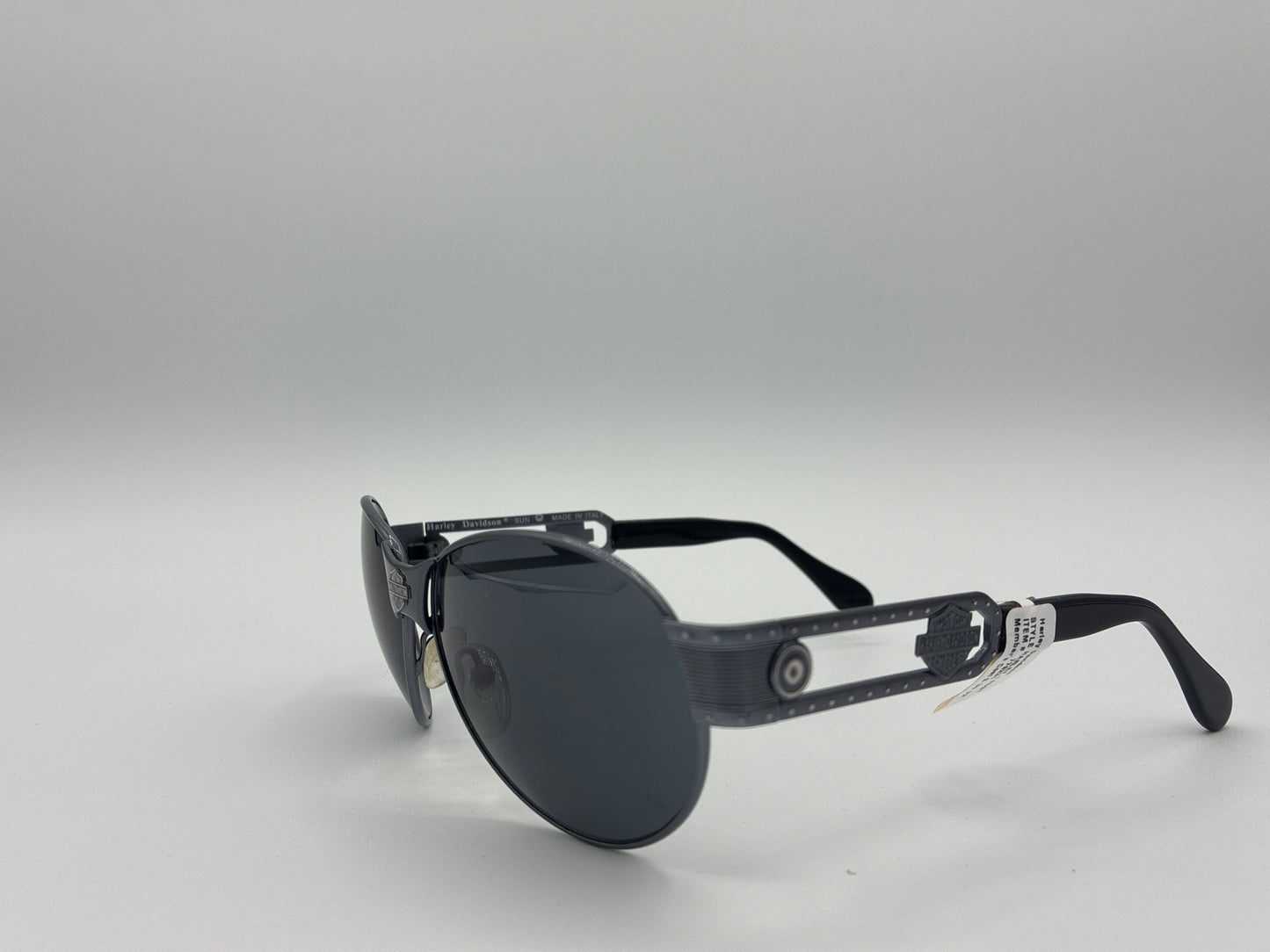 Black sunglasses with reflective lenses on a gray background
