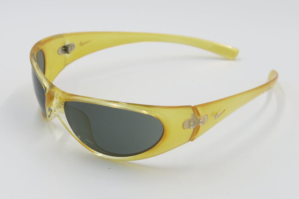 Yellow Nike Volition II sunglasses with dark lenses on a white background