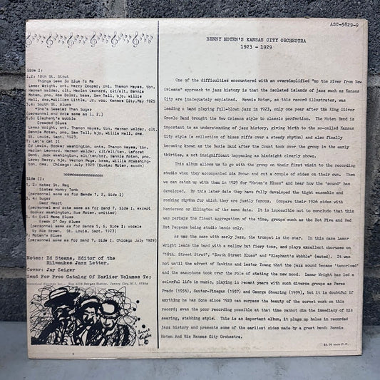 An archival music program booklet from the 1953-1954 season of the Henry Woodth Kansas City Orchestra, featuring printed text on aged off-white paper with a black-and-white illustration of a violin at the bottom left.