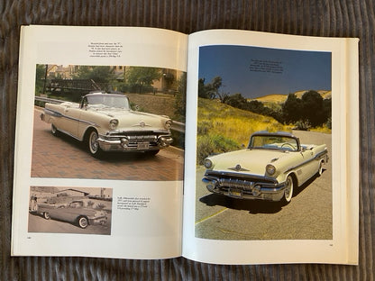 Open book showing images of a classic car on a road with a scenic background.