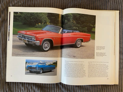Open book showing images of classic cars on a textured surface