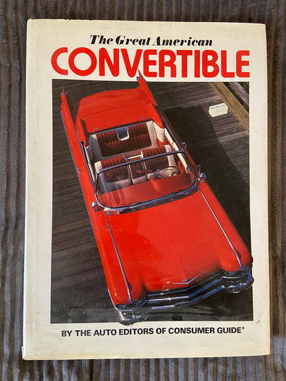 Book cover of 'The Great American Convertible' with a red convertible car illustration on a wooden surface.