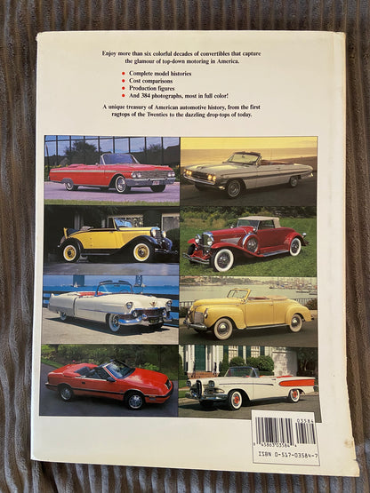 Bookback with images of classic cars and text on a wooden surface