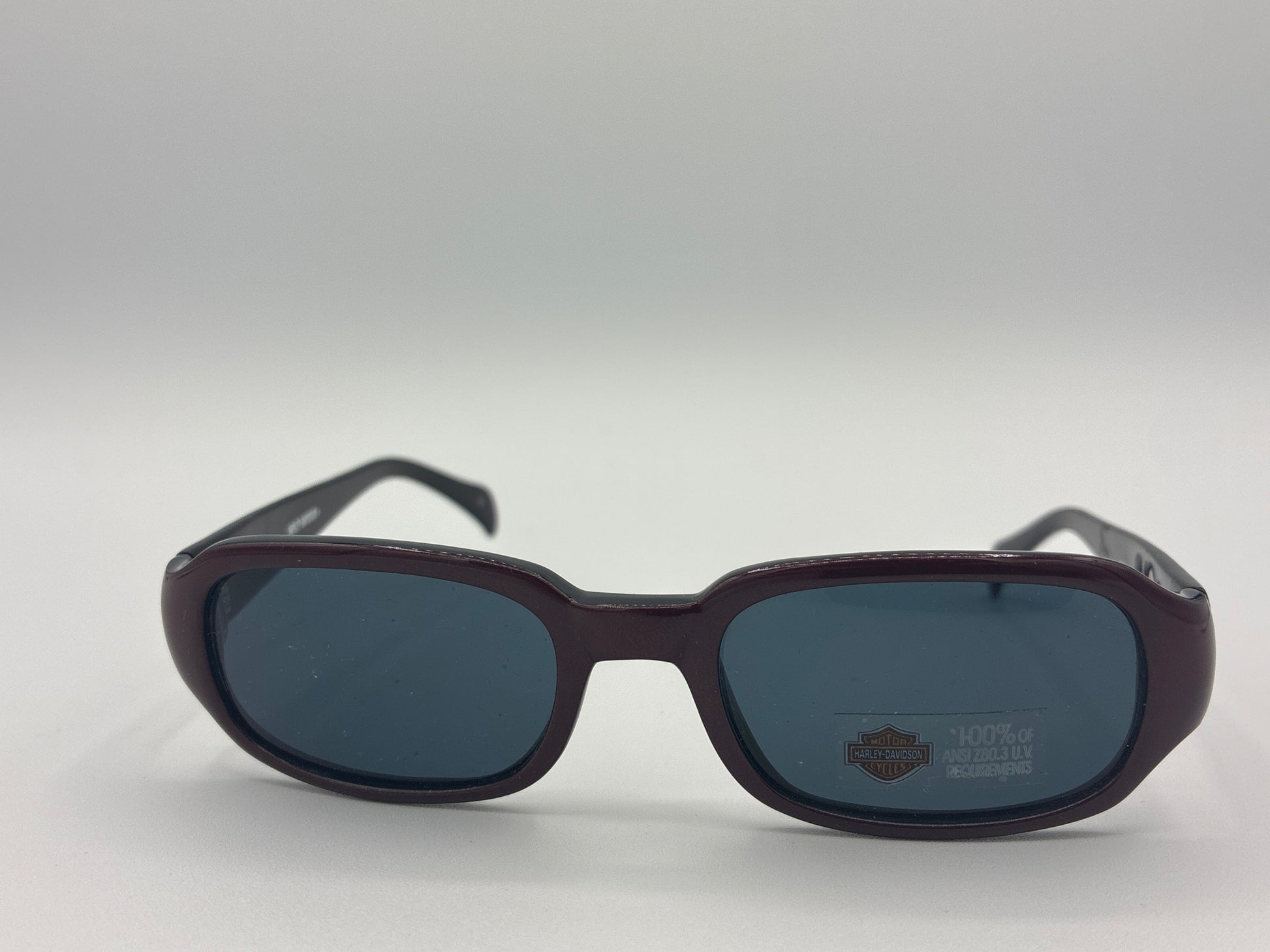 Sunglasses with dark lenses and brown frame on a white background