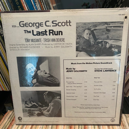 Vinyl record cover for 'The Last Run' with text and images on a stack of records.