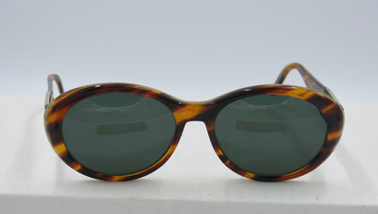 A pair of tortoise-patterned Paloma Picasso sunglasses with a case.