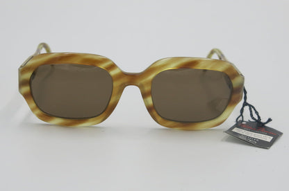 Sunglasses with tortoiseshell frame and brown lenses on a white background