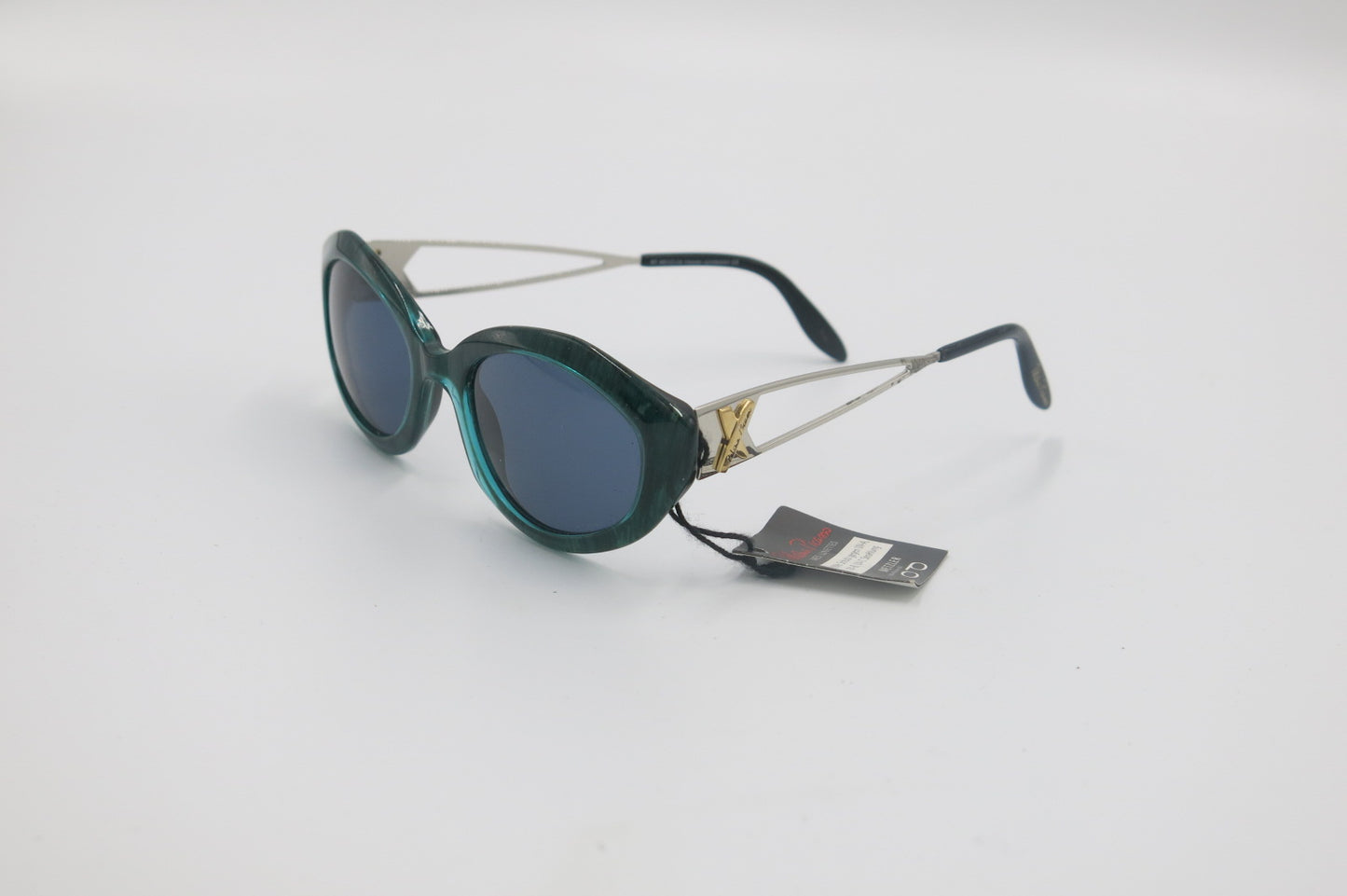 Sunglasses with a brand tag on a light gray background