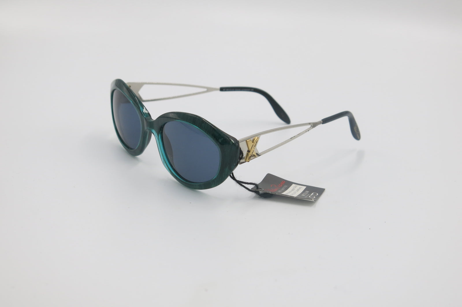 Sunglasses with a brand tag on a light gray background