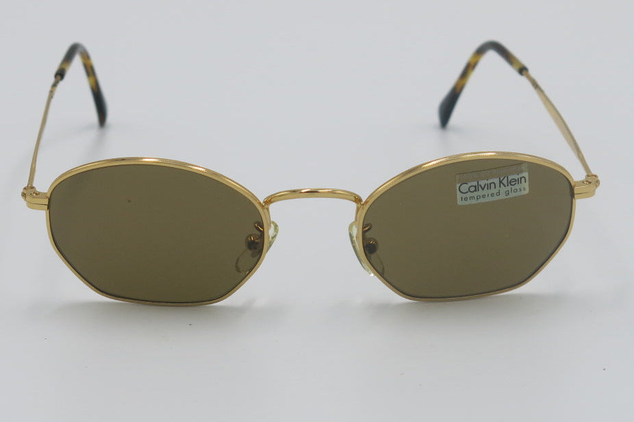 Gold-framed sunglasses on a white background