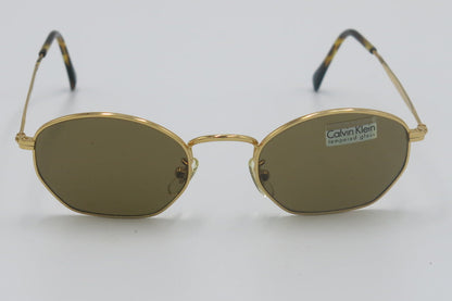 Gold-framed sunglasses on a white background