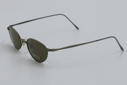 Sunglasses with thin metal frame on a light gray background