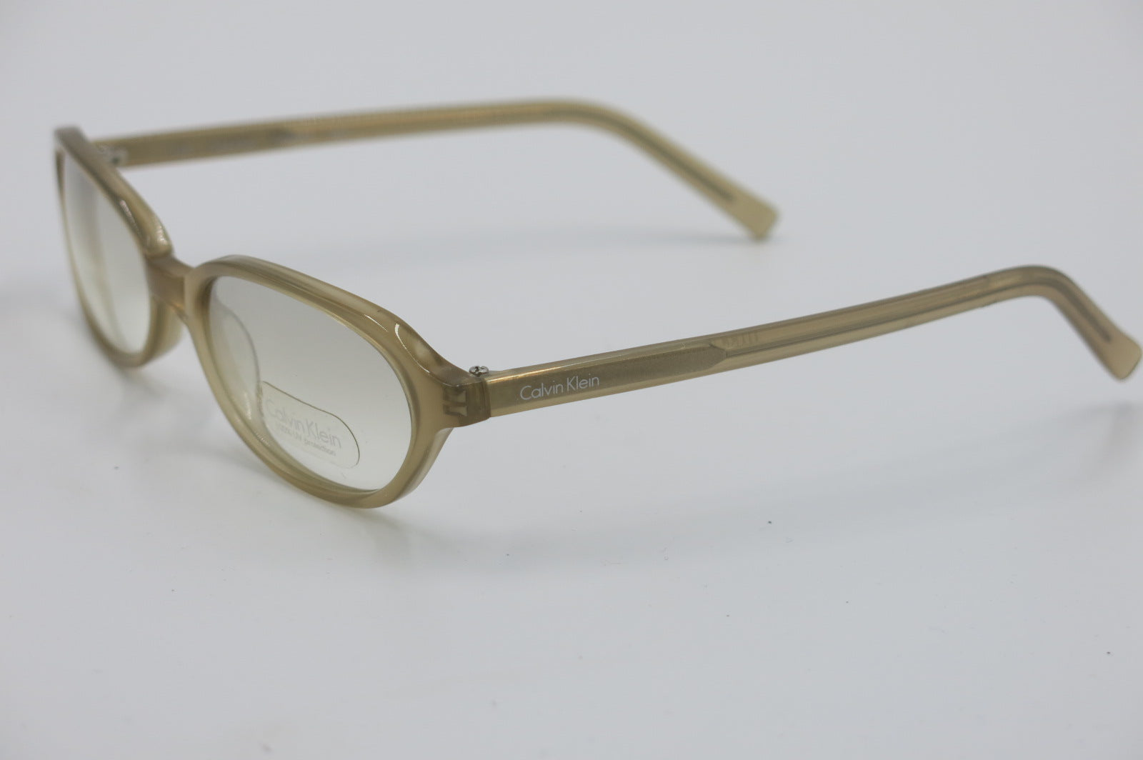 A pair of semi-transparent light brown eyeglass frames with clear lenses, shown on a plain white background.
