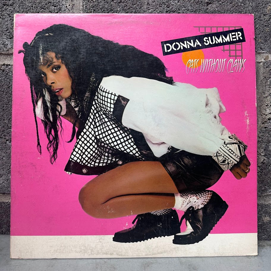 Vinyl record cover with a person in a grid-patterned outfit on a pink background