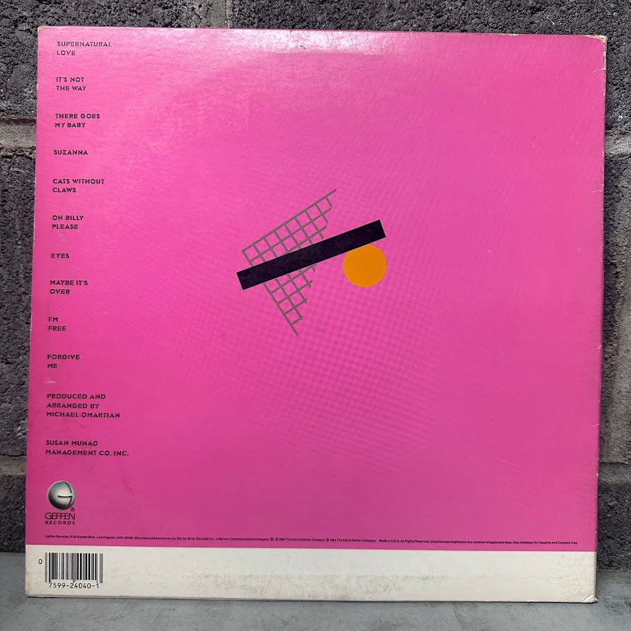 Pink vinyl record cover with geometric design on a textured surface