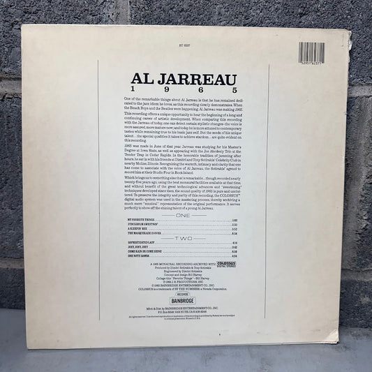 The back cover of a vinyl record sleeve for Al Jarreau's 1965 album 'One', photographed flat against a dark textured background. The cover is off-white with black text and a barcode.