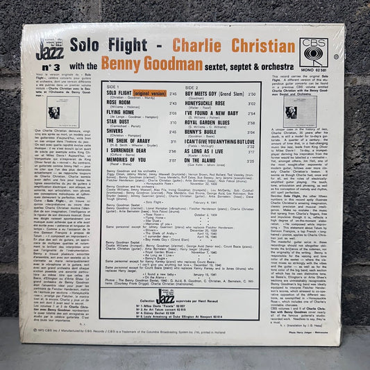 The back cover of a vinyl record sleeve for Charlie Christian's 'Solo Flight - No. 3' with Benny Goodman, photographed flat on a dark textured surface.