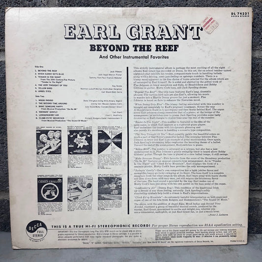 The back cover of a vintage vinyl record for Earl Grant's 'Beyond the Reef', showing track listings, reviews, and small album artwork on an off-white background.