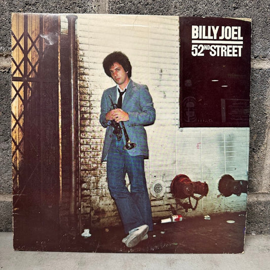 Vinyl record cover for '52nd Street' by Billy Joel against a textured wall.