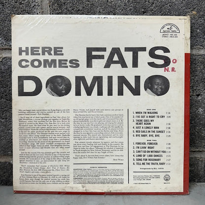 Vinyl record cover for 'Here Comes Fats Domino' with text and album details.