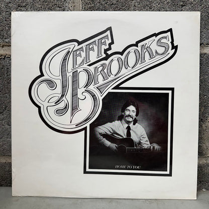 Vinyl record cover with 'Jeff Brooks' and a portrait of a man playing guitar.